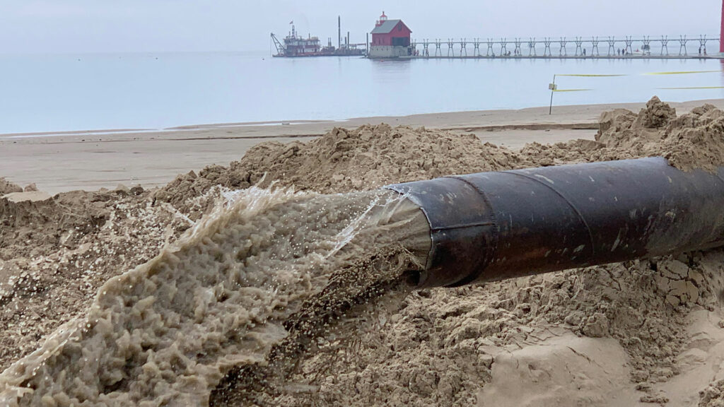 Dredging discharge pipe on beach in Grand Haven MI, The King Co., Inc.